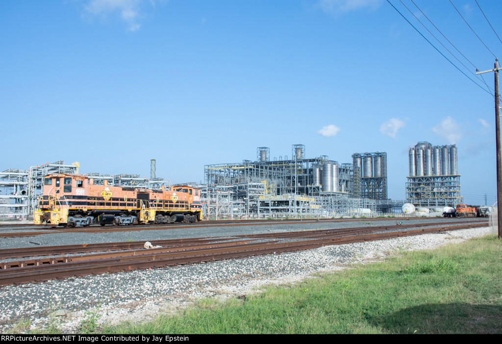 Two CCPN Switchers stands in front of the massive Corpus Christi Polymers LLC Plant